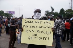 People demonstrate on the street to protest against police brutality in Lagos, Nigeria, Oct. 14, 2020, for a seventh day across Africa's most populous nation.