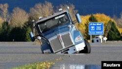 A truck is partially submerged on a flooded stretch of the Trans-Canada highway after rainstorms lashed the western Canadian province of British Columbia, triggering landslides and floods and shutting highways, in Abbotsford, British Columbia, Canada Nove