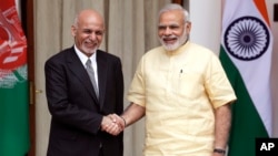  FILE - Indian Prime Minister Narendra Modi (right) shakes hands with Afghan President Ashraf Ghani before a meeting in New Delhi, India, Sept. 14, 2016. 