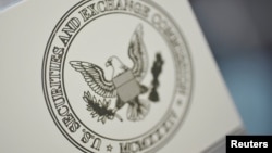 FILE - The U.S. Securities and Exchange Commission logo adorns an office door at the SEC headquarters in Washington.