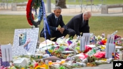 President Barack Obama and Vice President Joe Biden visit a memorial to the victims of the Pulse nightclub shooting, Thursday, June 16, 2016 in Orlando, Fla. Offering sympathy but no easy answers, Obama came to Orlando to try to console those mourning the deadliest shooting in modern U.S history. (AP Photo/Pablo Martinez Monsivais)