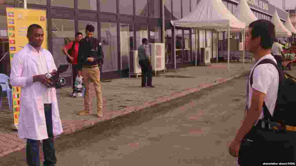 Doctors test passengers' temprature as they arrive in Bata, Equatorial Guinea