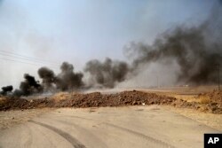 Smoke rises from Islamic state positions after an airstrike by coalition forces in villages surrounding Mosul, in Khazer, about 30 kilometers east of Mosul, Iraq, Oct. 17, 2016.