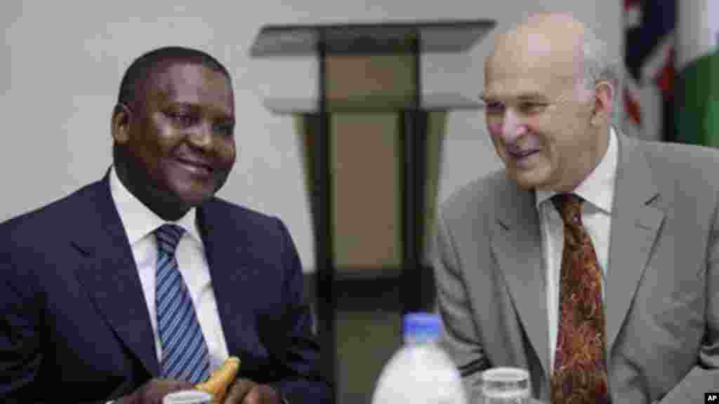 Britain's business secretary, Vince Cable, right, and billionaire businessman, Aliko Dangote, left, attend a meeting in Lagos.