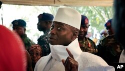 Gambia's president Yahya Jammeh shows his inked finger before voting in Banjul, Gambia, Dec. 1, 2016.