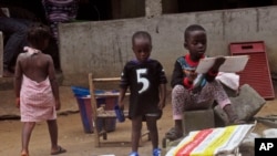 FILE - Liberian children stand in front of their home that has been placed under Ebola quarantine in this July 2015 photo.