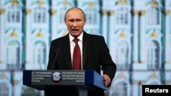 Russia's President Vladimir Putin delivers a speech during a session of the St. Petersburg International Economic Forum 2014 in St. Petersburg, May 23, 2014. 