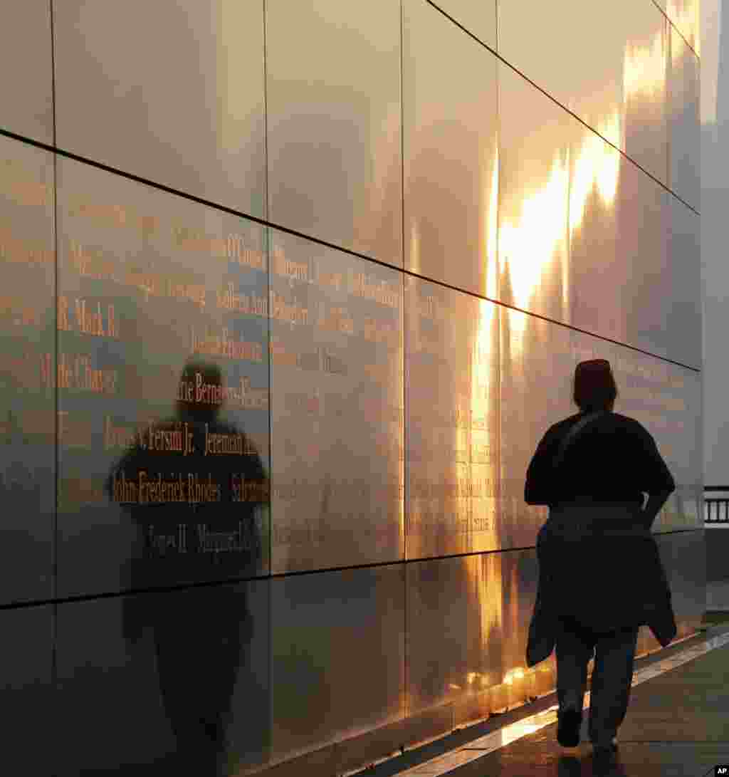 The sun reflects off the stainless steel wall of the "Empty Sky" memorial to New Jersey's victims of the Sept. 11, 2001 terrorist attacks, Sept. 11, 2013, in Jersey City, N.J. 