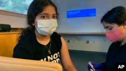 FILE - Maya Huber takes part in Pfizer COVID-19 vaccine study at Rutgers University on June 14 2021 in New Brunswick, N.J. Maya does not know if she is receiving the vaccine or the placebo. (Nisha Gandhi via AP)
