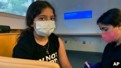 미국 뉴저지주 뉴브런즈윅의 럿거스대학교 의료시설에서 여자 어린이가 화이자 코로나 백신을 맞고 있다. (자료사진)