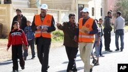 Members from Arab League observers delegation visit al-Msefra town near Deraa, southern Syria, January 5, 2012, in this handout photograph released by Syria's national news agency SANA.