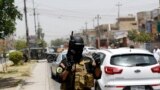 A member of the Iraqi Special Operations Forces stands guard during an intensive security deployment in Baghdad's Amiriya district, June 18, 2014. 