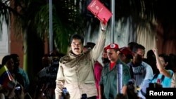 Venezuelan President Nicolas Maduro greets supporters after receiving a law which grants him with decree powers in Caracas, Nov. 19, 2013.