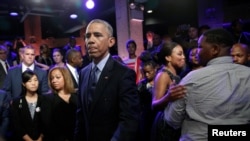 U.S. President Barack Obama meets members of the audience, including Cameron Sterling (R), son of Alton Sterling who was shot and killed by white police officers in Baton Rouge, after taking part in a televised town hall about trust and safety in our comm