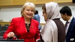 Australia's Ambassador for Women and Girls for the Department of Foreign Trade and Affairs, Sharman Stone (left) speaks with Afghanistan's Minister for Women's Affairs Alhaj Delbar Nazari (center) as they attend the conference, She Decides, in Brussels.