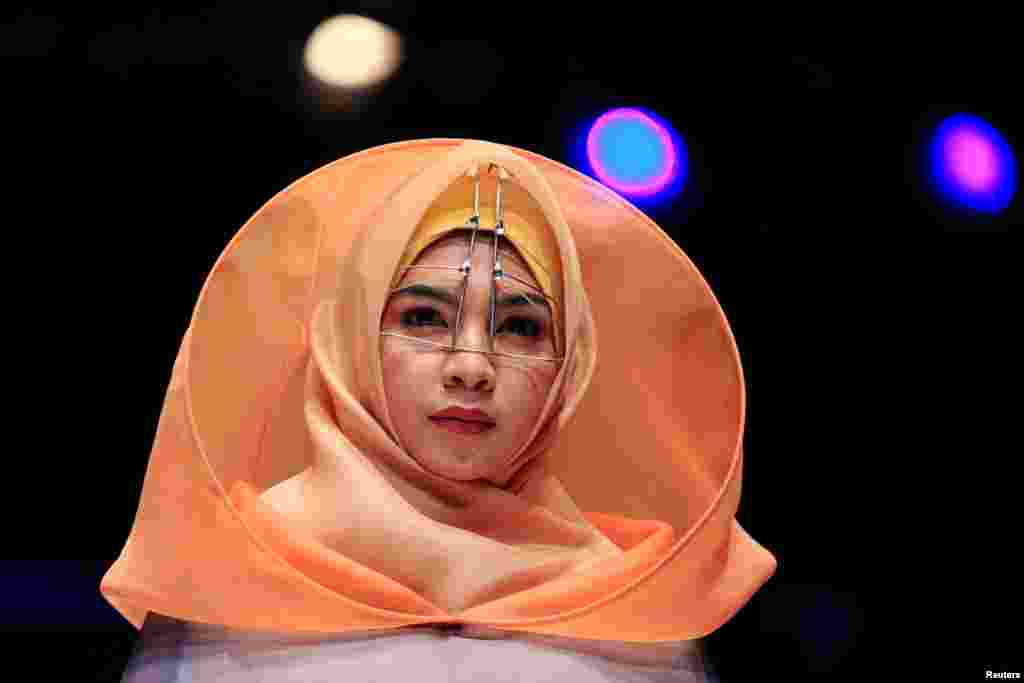 A model presents creations by student designer Sherly Az Zahra on the first day of the Indonesia Muslim Fashion Festival in Jakarta, Indonesia.