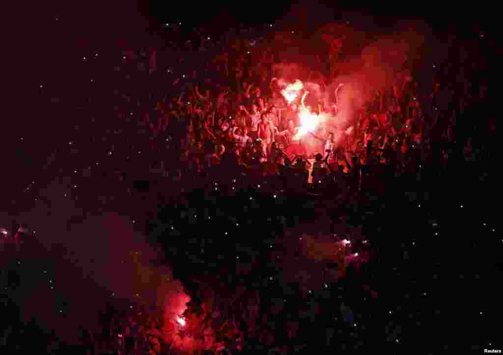 River Plate fans light flares as they cheer before of the Copa Sudamericana second leg semi-final soccer match against Boca Juniors in Buenos Aires.