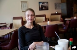 Ashley Chandler, 33, sits in the restaurant where she works as a waitress in Lula, Georgia, in Hall County, Jan. 10, 2017.