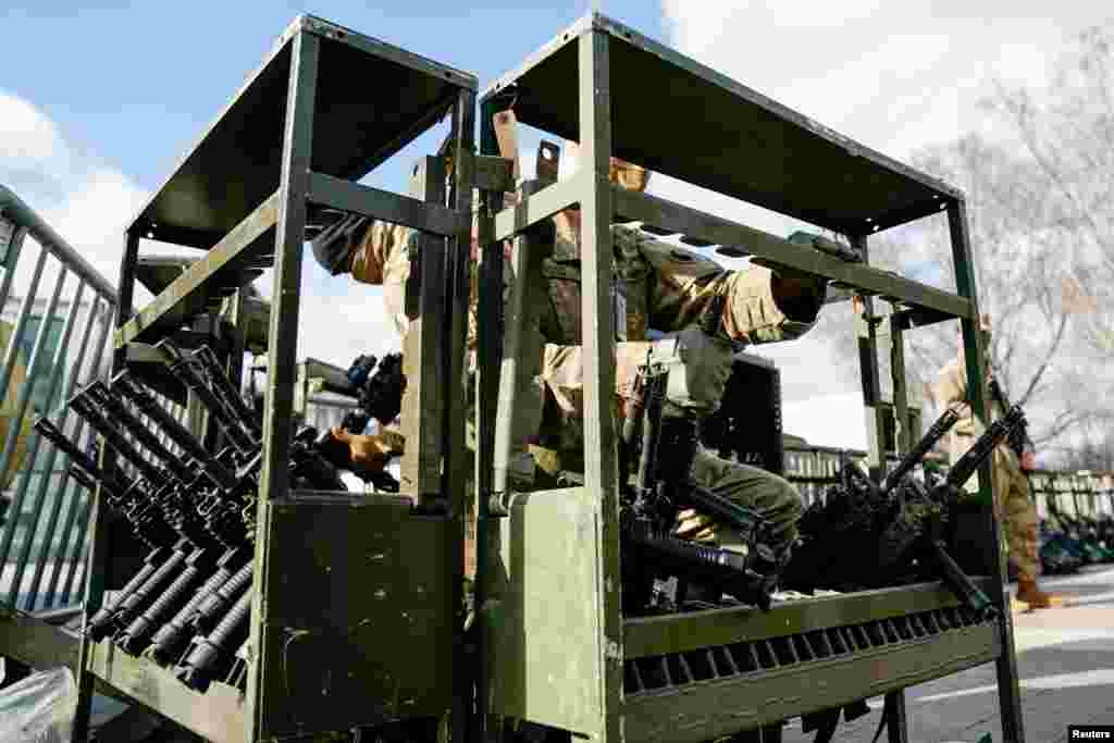 National guard troops receive guns at the U.S. Capitol as security tightens ahead of presidential inaugural events on Capitol Hill in Washington, D.C., Jan. 17, 2021.