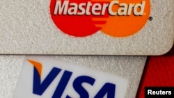 FILE - MasterCard and VISA credit cards are seen in this illustrative photograph taken in Hong Kong, Dec. 8, 2010.