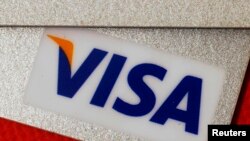 FILE - VISA credit cards are seen in this illustrative photograph taken in Hong Kong, Dec. 8, 2010.