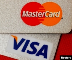 FILE - MasterCard and VISA credit cards are seen in this illustrative photograph taken in Hong Kong, Dec. 8, 2010.