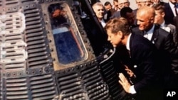 Astronaut John Glenn, right, shows his Friendship 7 space capsule to President John F. Kennedy at Cape Canaveral, Florida, in 1962