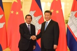 In this photo taken on April 29, 2019, Cambodia’s Prime Minister Hun Sen shakes hands with China's President Xi Jinping before their meeting at the Great Hall of the People in Beijing, China.