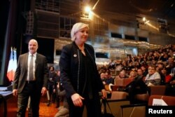 FILE - Marine Le Pen, leader of what was then called the National Front party, attends a news conference during the party's convention in Lille, France, March 10, 2018.