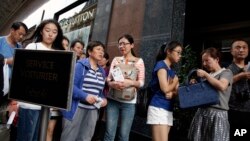 FILE - Chinese tourists queue outside the Galeries Lafayette general store in Paris, France, Wednesday, Aug. 26, 2015. 