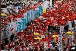Protesters march along a downtown street against the proposed amendments to an extradition law in Hong Kong, June 9, 2019.