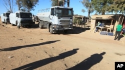 FILE: Police vehicles and water canons parked on the outskirts of the city following a job boycott started via social media platforms, in Harare, Wednesday, July,6, 2016. (AP Photo/Tsvangirayi Mukwazhi)