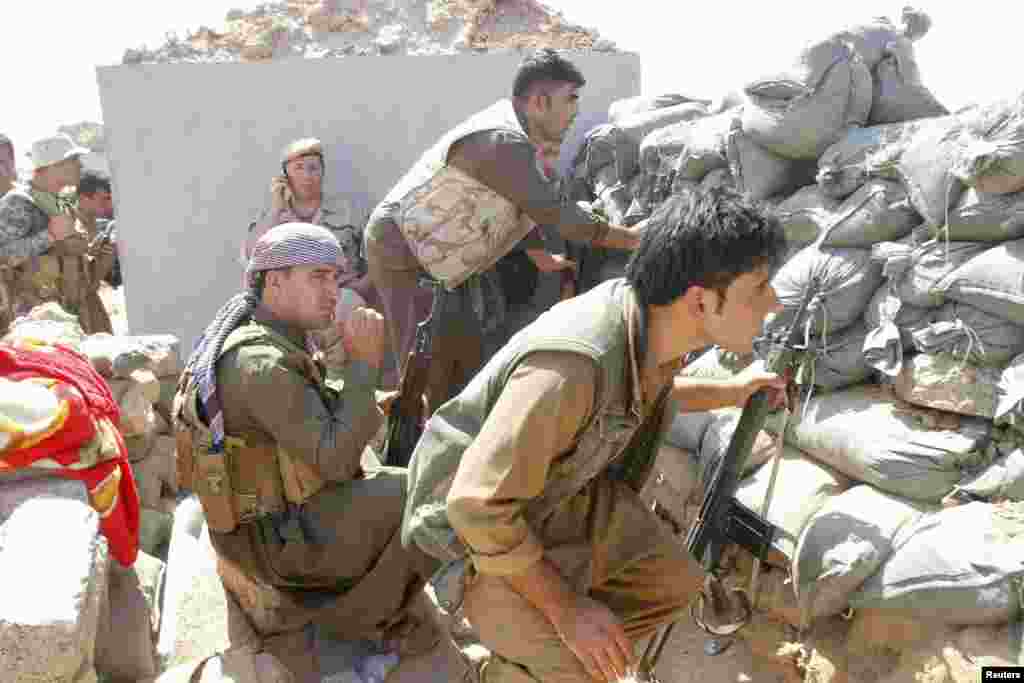 Kurdish peshmerga forces clash with Islamic State militants in the town of Daquq, south of Kirkuk, Sept. 30, 2014. 