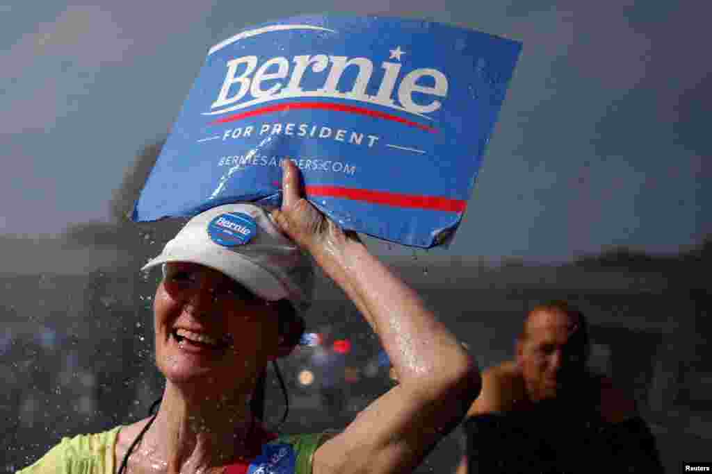A supporter of U.S. Senator Bernie Sanders walks past a water hydrant during a protest march ahead of the 2016 Democratic National Convention in Philadelphia, July 24, 2016.