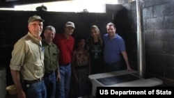 Special Representative Kris Balderston and a delegation of representatives from public and private sectors participate in building a clean cook stove in Antigua, Guatemala as part of the Global Partnership Initiative. 