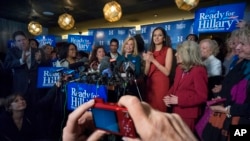 Rep. Carolyn Maloney, D-N.Y., center, speaks as a person takes a photograph during the "Last Hillary Clinton Rally" as part of the Ready For Hillary campaign in New York, April 11, 2015. 