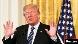 FILE - U.S. President Donald Trump gestures as he delivers remarks at the White House in Washington, May 18, 2018. 
