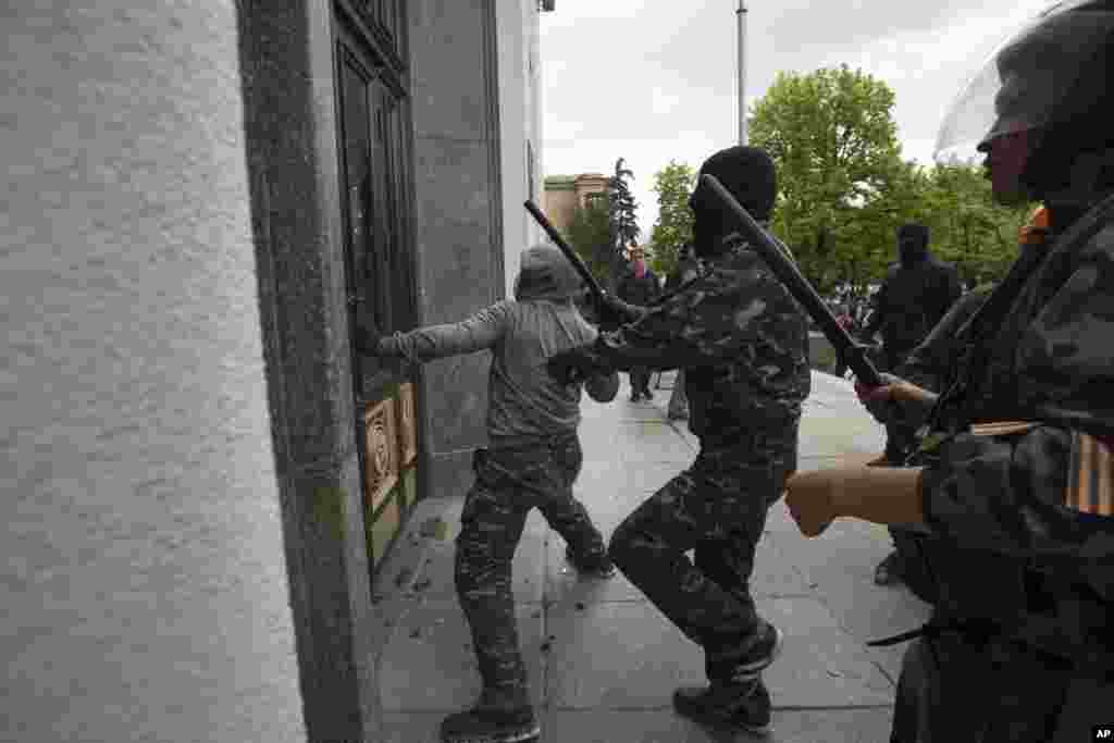 Pro-Russian activists storm an administration building in the center of Luhansk, Ukraine, one of the largest cities in Ukraine's troubled east, April 29, 2014. 