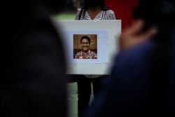 An activist holds a picture of Wanchalearm Satsaksit, 37, a Thai political activist who was abducted by unknown gunmen in front of his Phnom Penh apartment, during a protest for his disappearance in Bangkok, Thailand, June 5, 2020.