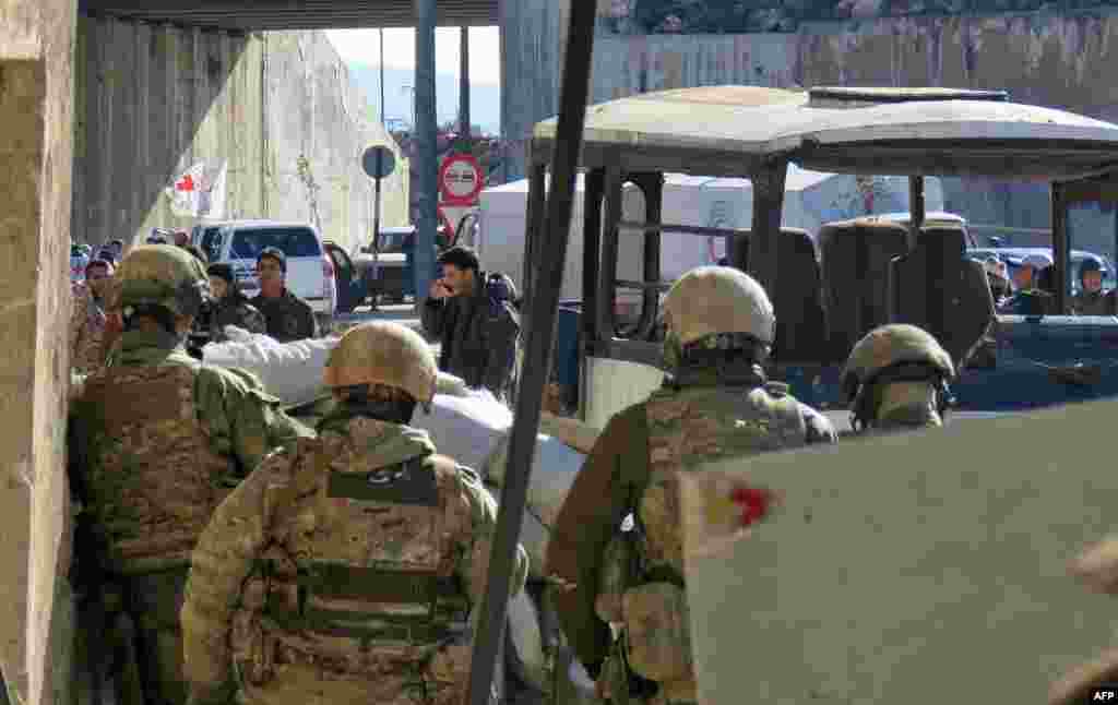 Russian soldiers gather in the government held side of the embattled city of Aleppo before the start on an evacuation operation of rebel fighters and their families from rebel-held areas on Dec. 15, 2016. 