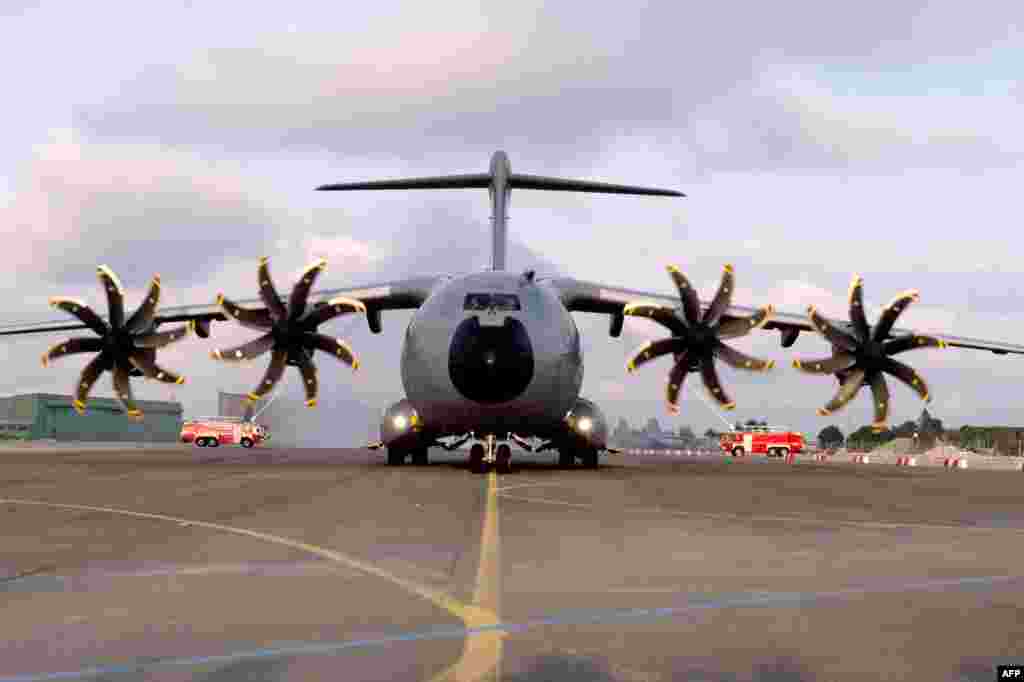 The new French air force military transport Airbus A 400M is welcomed by fire engines at the military airbase BA 123 in Saint-Jean-de-la-Ruelle near Orleans (central France) as part of an official presentation. 