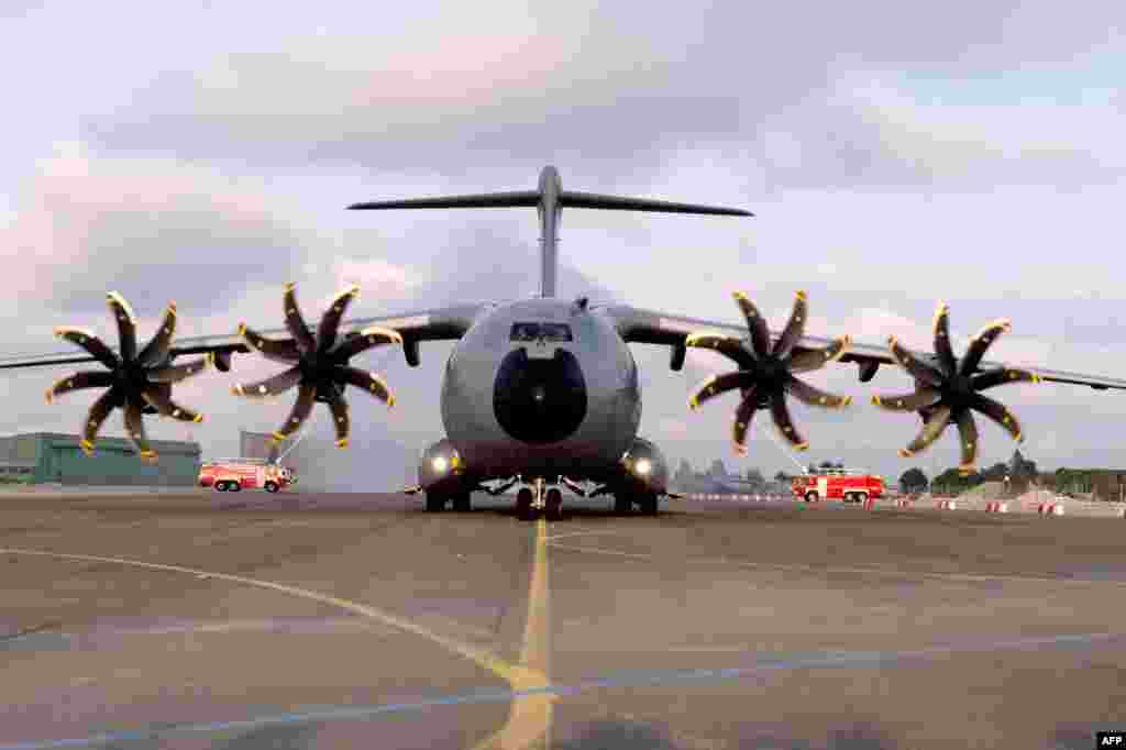 The new French air force military transport Airbus A 400M is welcomed by fire engines at the military airbase BA 123 in Saint-Jean-de-la-Ruelle near Orleans (central France) as part of an official presentation.