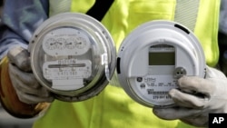 FILE - New "smart" meter, right, will give customers, who are already using less energy, the opportunity to save money by accurately tracking consumption.