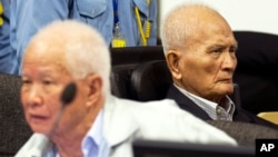 FILE - Khieu Samphan, left, former Khmer Rouge head of state, and Nuon Chea, Khmer Rouge's chief ideologist and No. 2 leader, sit in the court room before they made closing statements at the U.N.- backed war crimes tribunal in Phnom Penh, Oct. 31, 2013. 