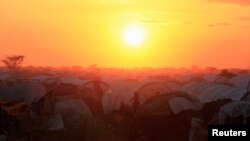 FILE - The sun sets over the Ifo extension refugee camp in Dadaab, near the Kenya-Somalia border, in Garissa County, Kenya, July 31, 2011.