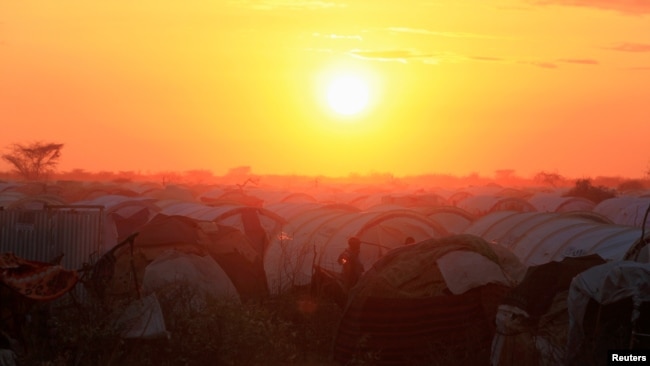 FILE - The sun sets over the Ifo extension refugee camp in Dadaab, near the Kenya-Somalia border, in Garissa County, Kenya, July 31, 2011.