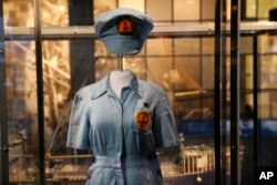 A female ordinance plant worker's uniform is part of the permanent exhibit "Salute to the Home Front." The exhibit tells the home front story from the 1920s to the development of the atomic bomb.