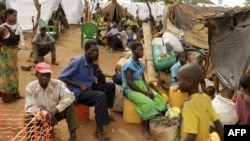 FILE - Newly arrived Mozambican refugees wait for registration at the Kapise refugee camp in the Mwanza district on the Malawian Mozambican border, Jan. 7, 2015, in Malawi.