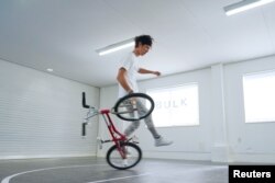 Takahiro Ikeda, 31, breaks the new Guinness World Record for "Most BMX Stick B in 30 seconds" in Chiba, Japan October 20, 2021. (Courtesy of Guinness World Records 2021/Masakazu Senda/Handout via REUTERS)