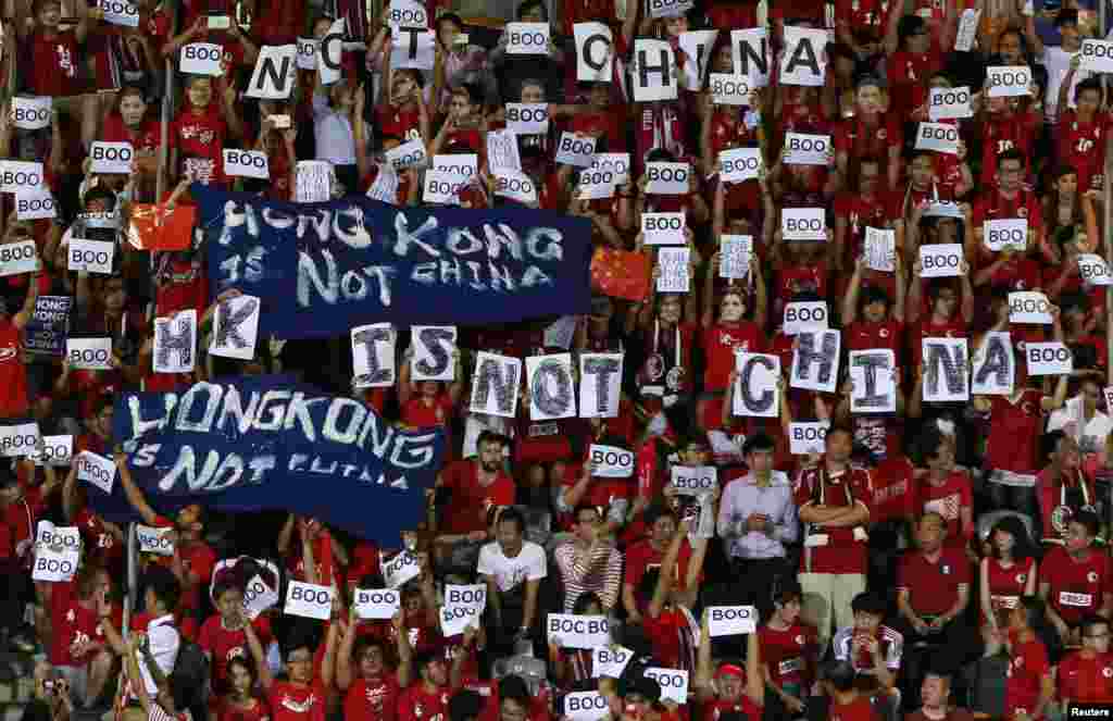 Hong Kong fans hold banners which read &quot;Hong Kong is not China,&quot; during the 2018 World Cup qualifying match between Hong Kong and China, in Hong Kong, Nov. 17, 2015. Fans booed the playing of the Chinese national anthem during the match.